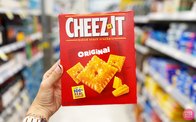 A Hand Holding Cheeze It Cracker Box in Walgreens Aisle