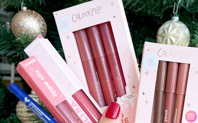 A hand holding ColourPop XOXO Bestie Lippie Stix Trio