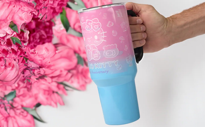 A Man Holding Hello Kitty 40 Ounce 50th Anniversary Stainless Steel Tumbler