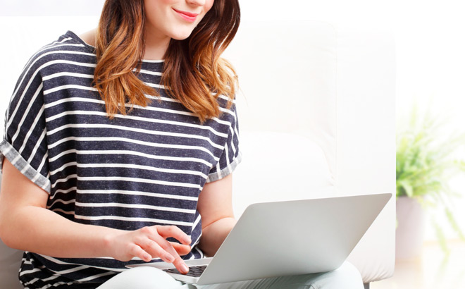A Person Answering Surveys on a Laptop