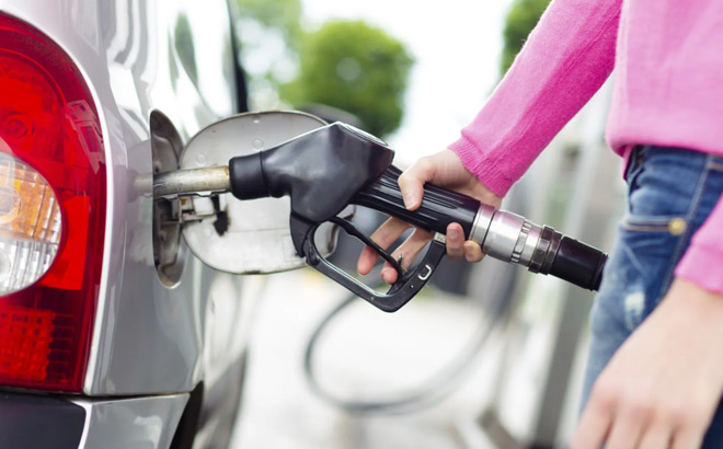 A Person Filling Up a Gas Tank