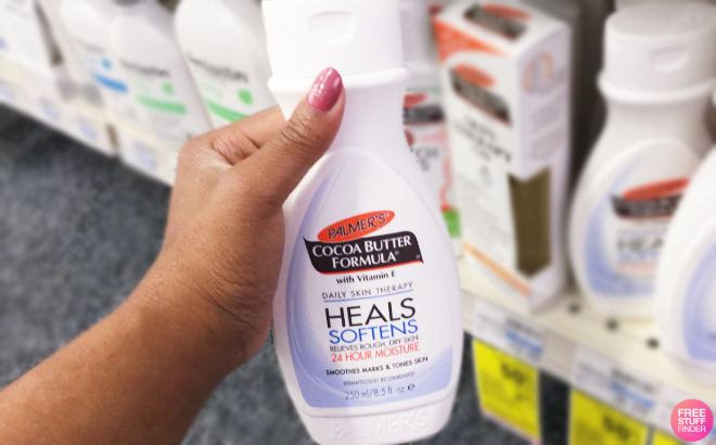 A Person Holding a Bottle of Palmers Cocoa Butter Formula Lotion