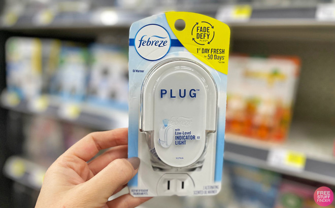 A Person Holding a Febreze Plug Warmer