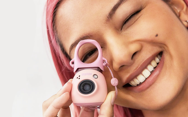 A Person Holding a Fujifilm Instax PAL Digital Camera