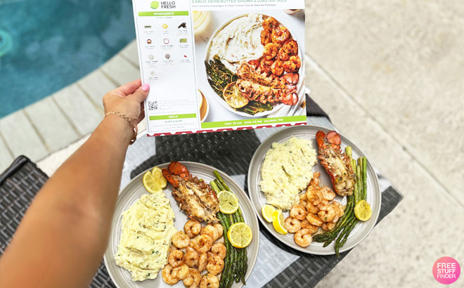 A Person Holding a Recipe next to Two Plates of Food