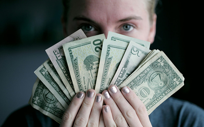 A Person Holding Bills of Money