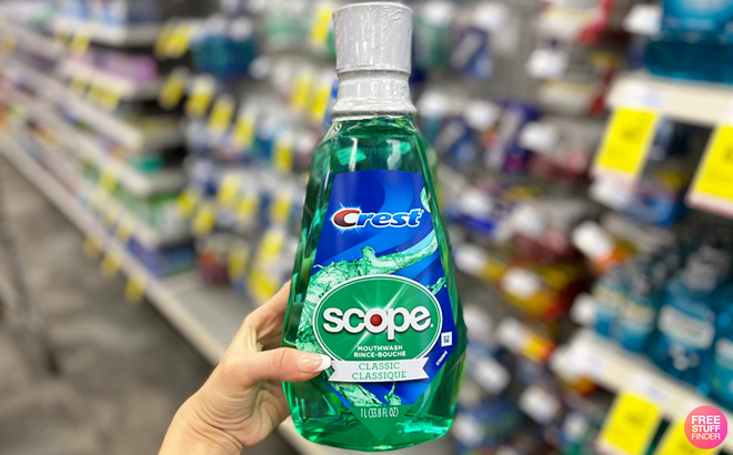A Person Holding Crest Scope Mouthwash at CVS
