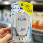 A Person Holding Febreze Odor Fighting Fade Defy Plug Air Freshener