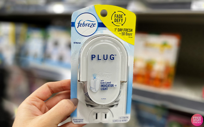 A Person Holding Febreze Odor Fighting Fade Defy Plug Air Freshener