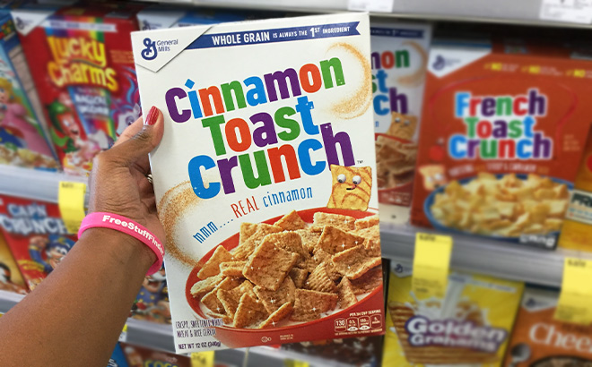 A Person Holding General Mills Cinnamon Toast Crunch Cereal