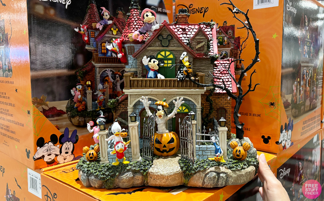 A Person Holding the Disney Halloween Party House with Lights Music at Costco