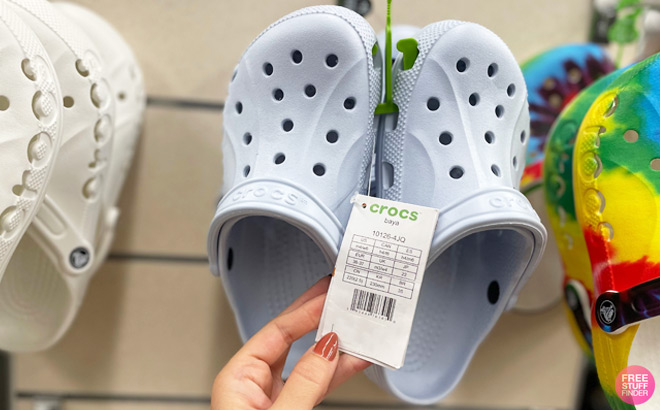 A Person Holidng a Tag on a Crocs Baya Clogs