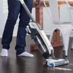 A Person using a Hart Cordless Stick Vacuum
