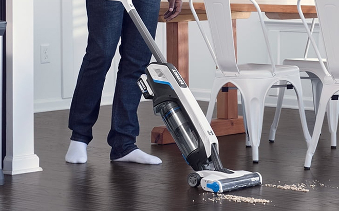 A Person using a Hart Cordless Stick Vacuum