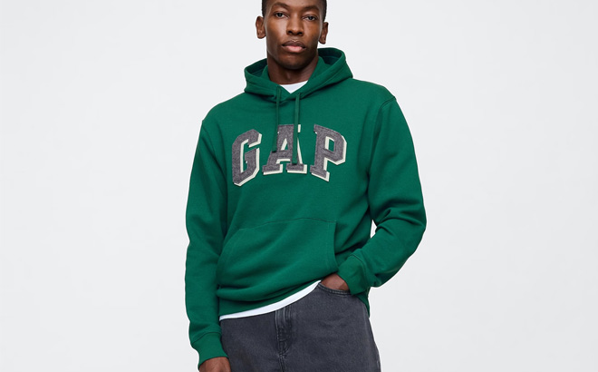 A Person Wearing GAP Factory Mens Relaxed Logo Hoodie in Green Color