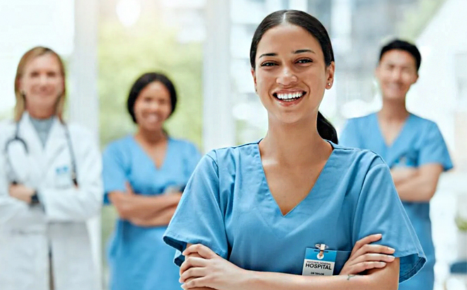 A Smiling Nurse with Coworkers in the Background