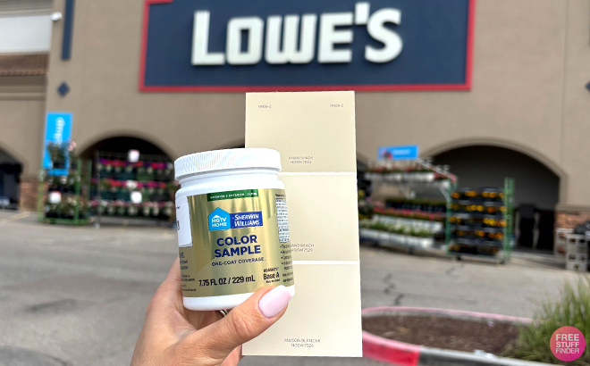 A Woman Holding a FREE Paint Sample in front of Lowe’s Store