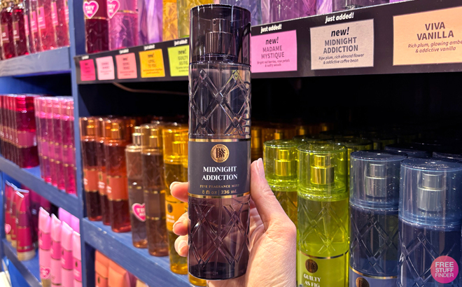 A Woman Holding Bath Body Works Midnight Addiction Fine Fragrance Mist