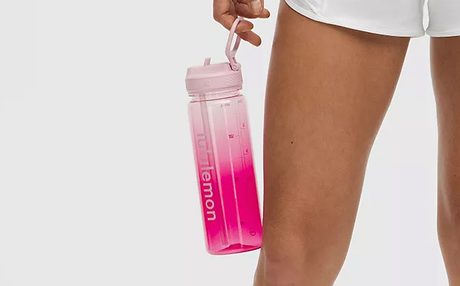 A Woman Holding Lululemon Back to Life Clear Bottle