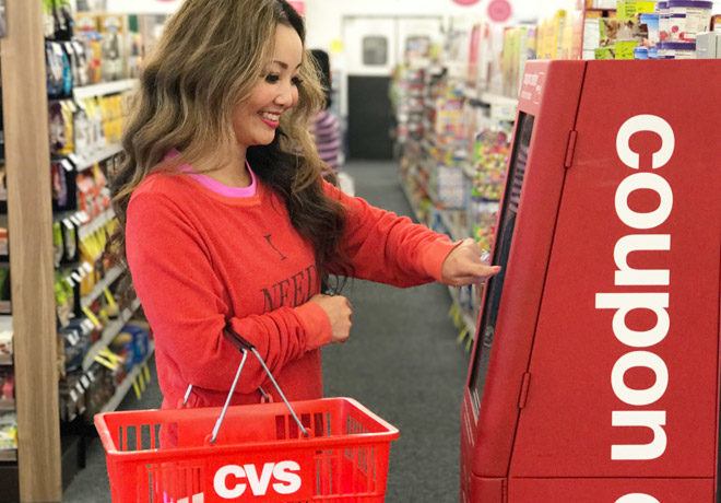 A Smiling Woman at the Red Coupon Machine at CVS