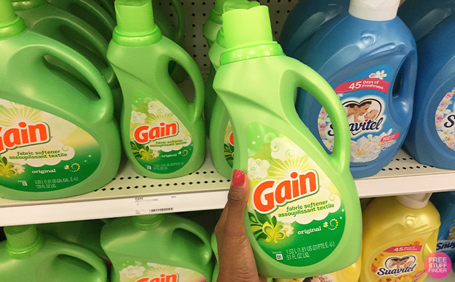 Hand Holding a Gain 60 Loads Laundry Liquid Fabric Softener