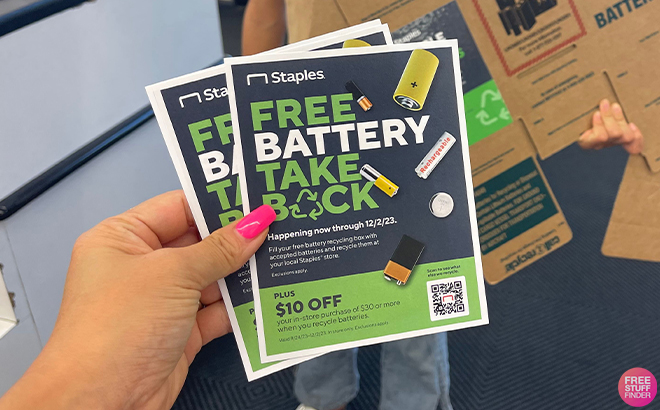 Hand Holding Battery Recycle Info Flyers at Staples