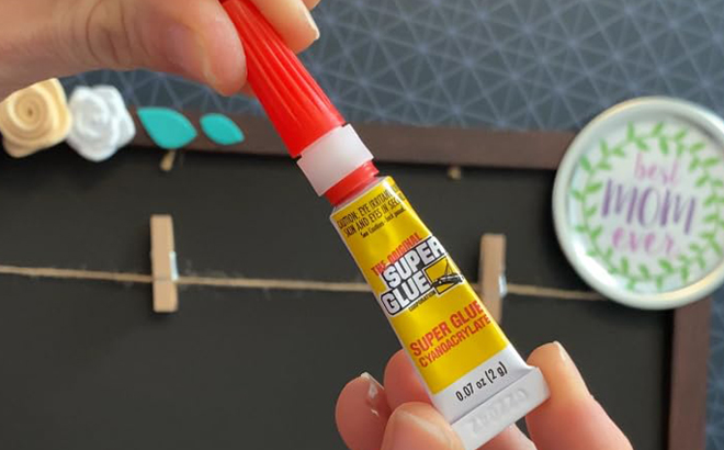 Hands holding a Super Glue