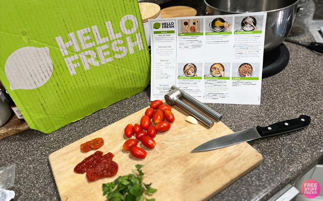 Hello Fresh Box and Cutting Board with Veggies and Recipe Instructions
