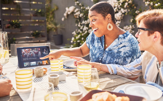 People Sitting at Kitchen Table and Streaming TV