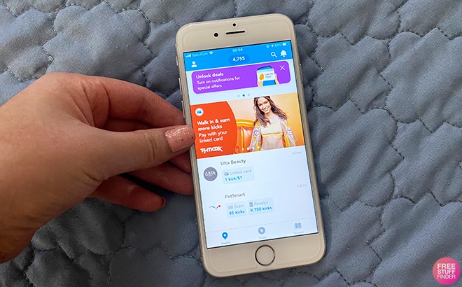 Hand Holding Phone with Shopkick App in the Background