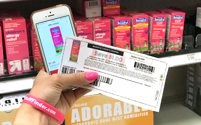 A Hand Holding a Coupon and Phone with Target Circle Open On It