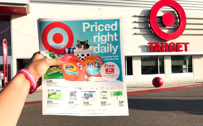 A Hand Holding a Target Weekly Ad in Front of Target